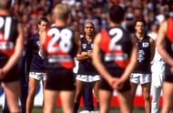 The Carlton <a href='https://www.sportskeeda.com/afl/carlton-blues' target='_blank' rel='noopener noreferrer'>Blues</a> and Essendon Bombers players line up for the national anthem before the AFL second preliminary final of 1999